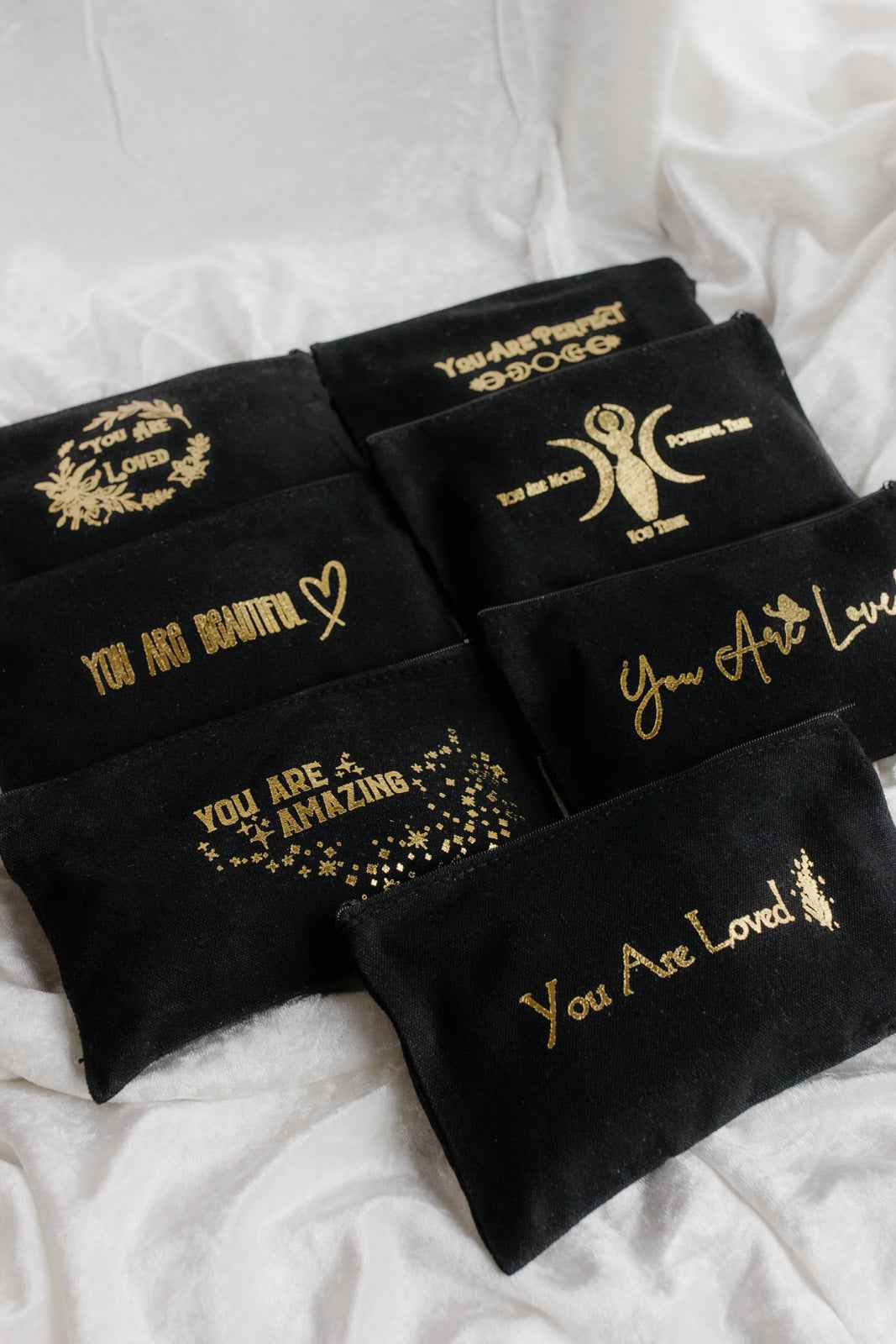 Menstrual Starter Kit Tween Period Supplies featuring black pouches with inspirational gold fonts.
