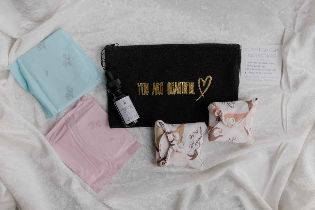 Menstrual Starter Kit Tween Period Supplies featuring black pouches with inspirational gold fonts.